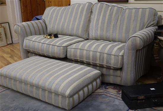 A modern upholstered striped fabric two seater sofa and footstool W.190cm and 110cm